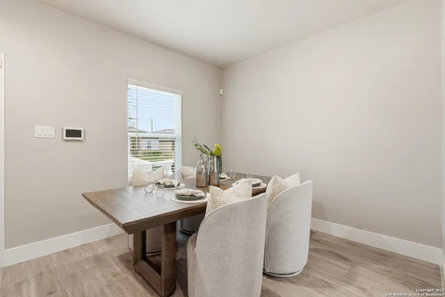 a view of a dining room with furniture and window