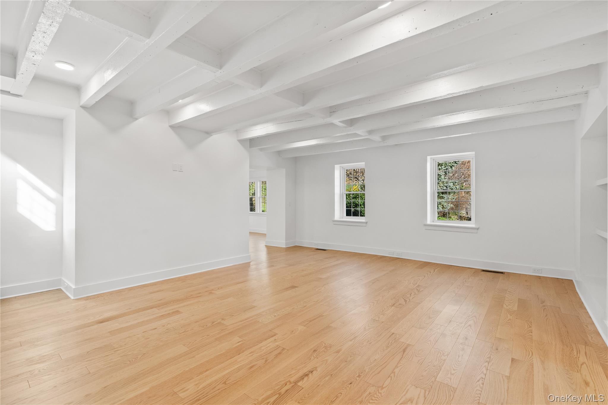 26 Latimer Lane Bronxville, NY 10708 - Photo 11 of 37 an empty room with wooden floor and windows