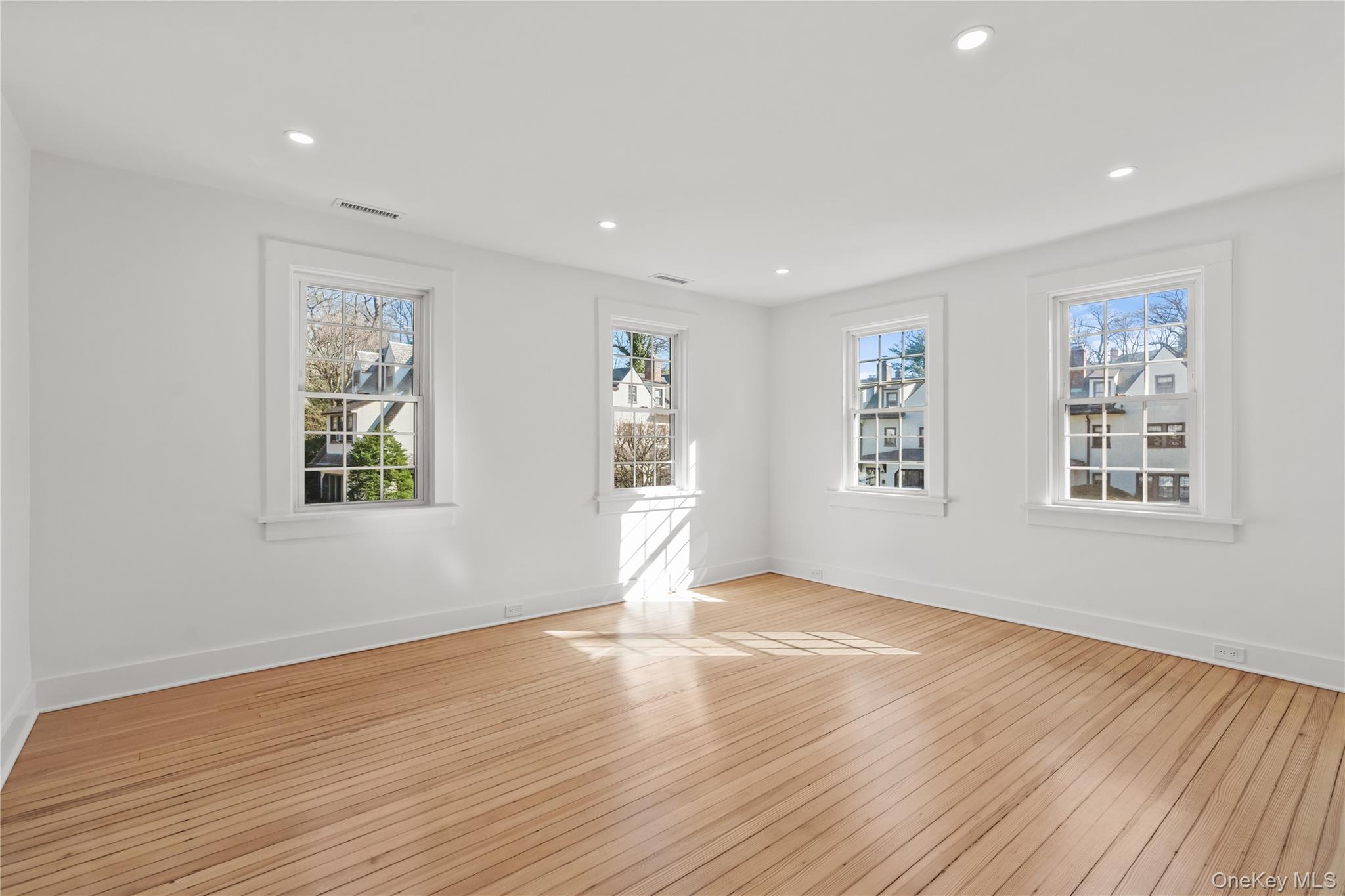 26 Latimer Lane Bronxville, NY 10708 - Photo 16 of 37 a view of an empty room with wooden floor and a window