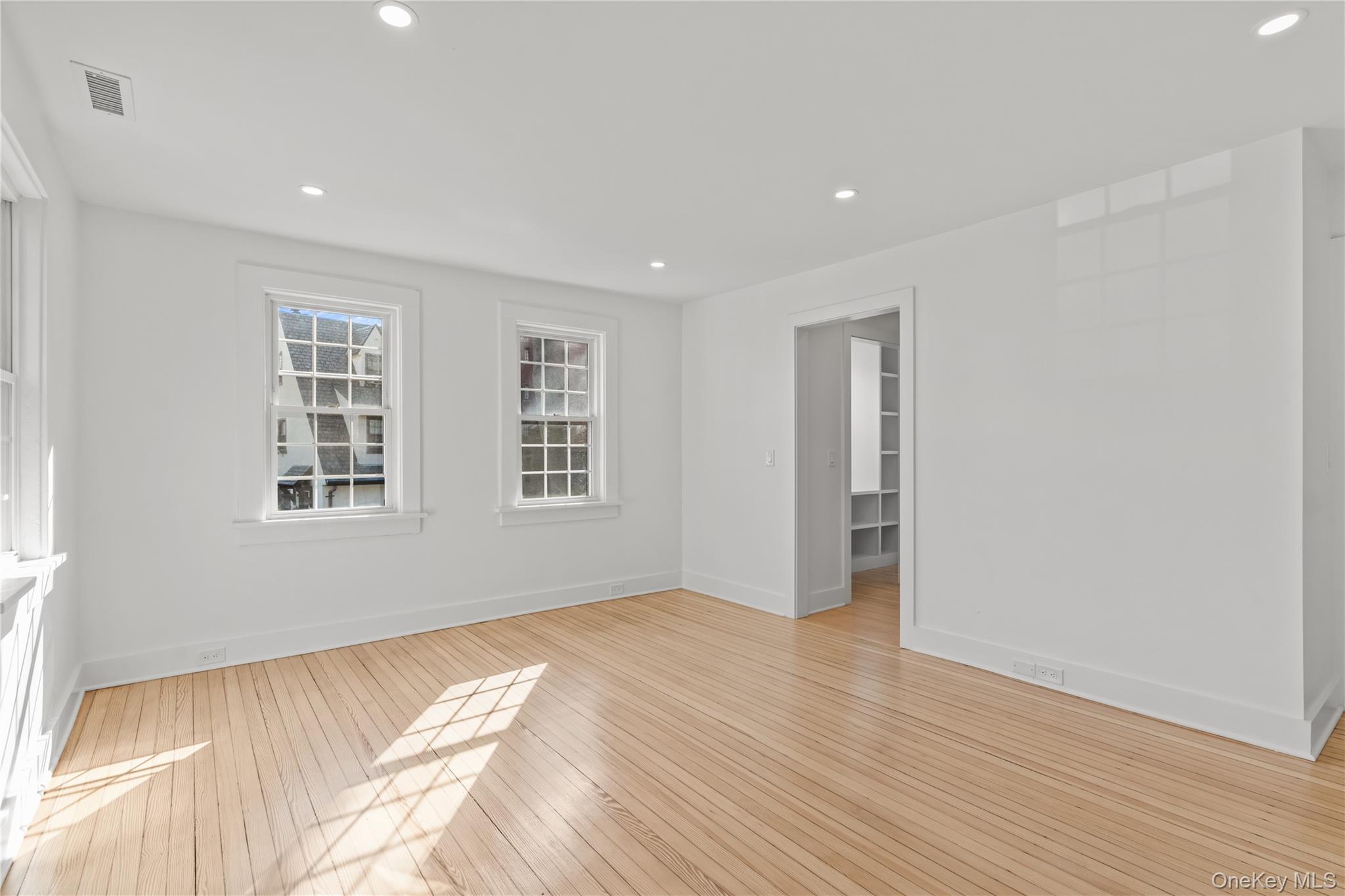 26 Latimer Lane Bronxville, NY 10708 - Photo 17 of 37 a view of an empty room with wooden floor and a window