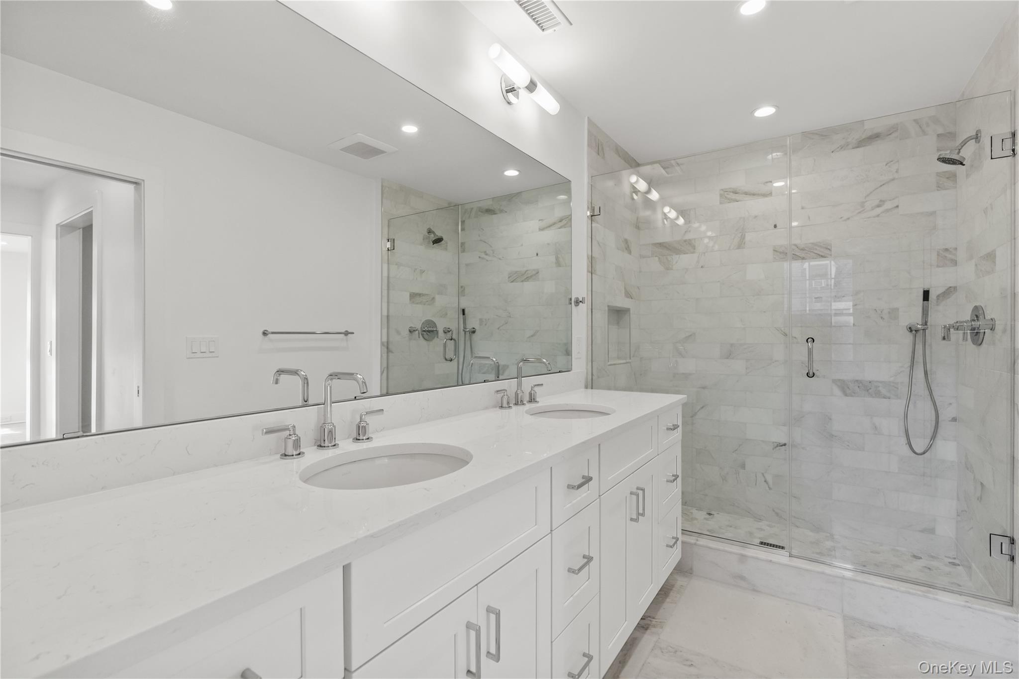 26 Latimer Lane Bronxville, NY 10708 - Photo 21 of 37 a bathroom with a double vanity sink mirror and shower