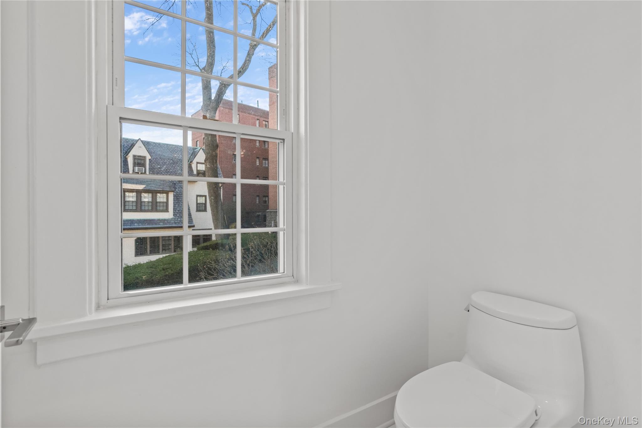 26 Latimer Lane Bronxville, NY 10708 - Photo 22 of 37 a white toilet sitting next to a window