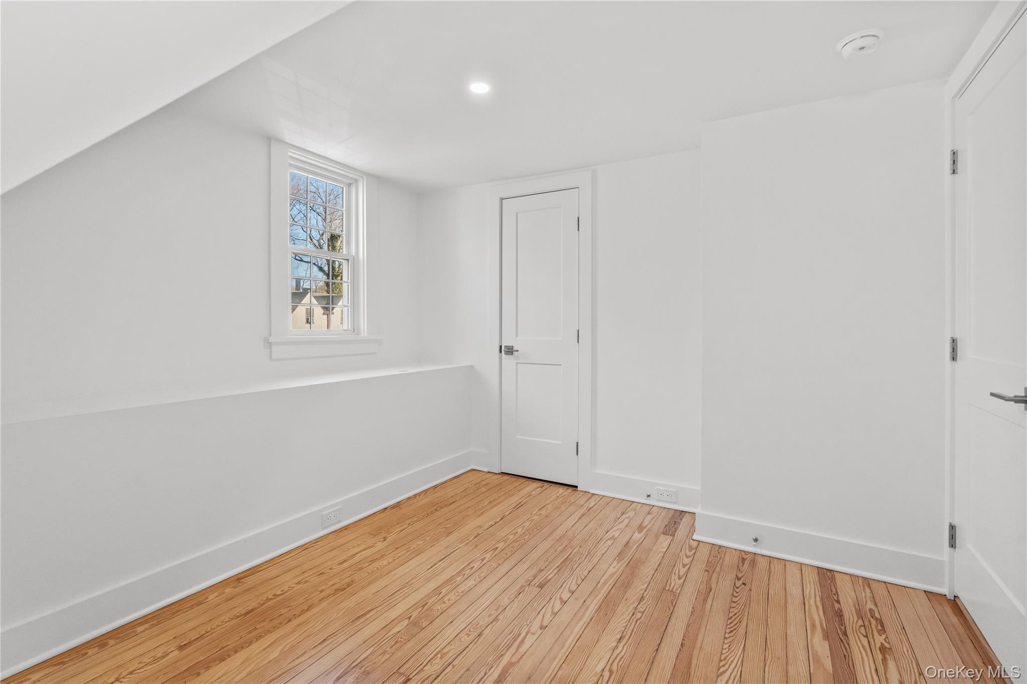 26 Latimer Lane Bronxville, NY 10708 - Photo 33 of 37 an empty room with wooden floor and windows