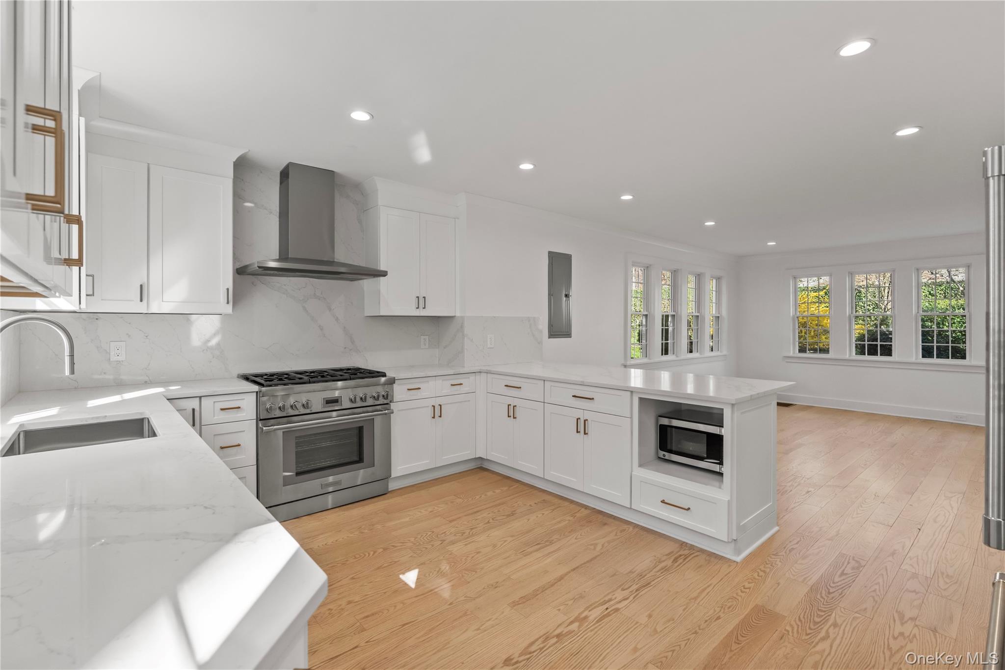 26 Latimer Lane Bronxville, NY 10708 - Photo 5 of 37 a kitchen with granite countertop a stove top oven sink and cabinets