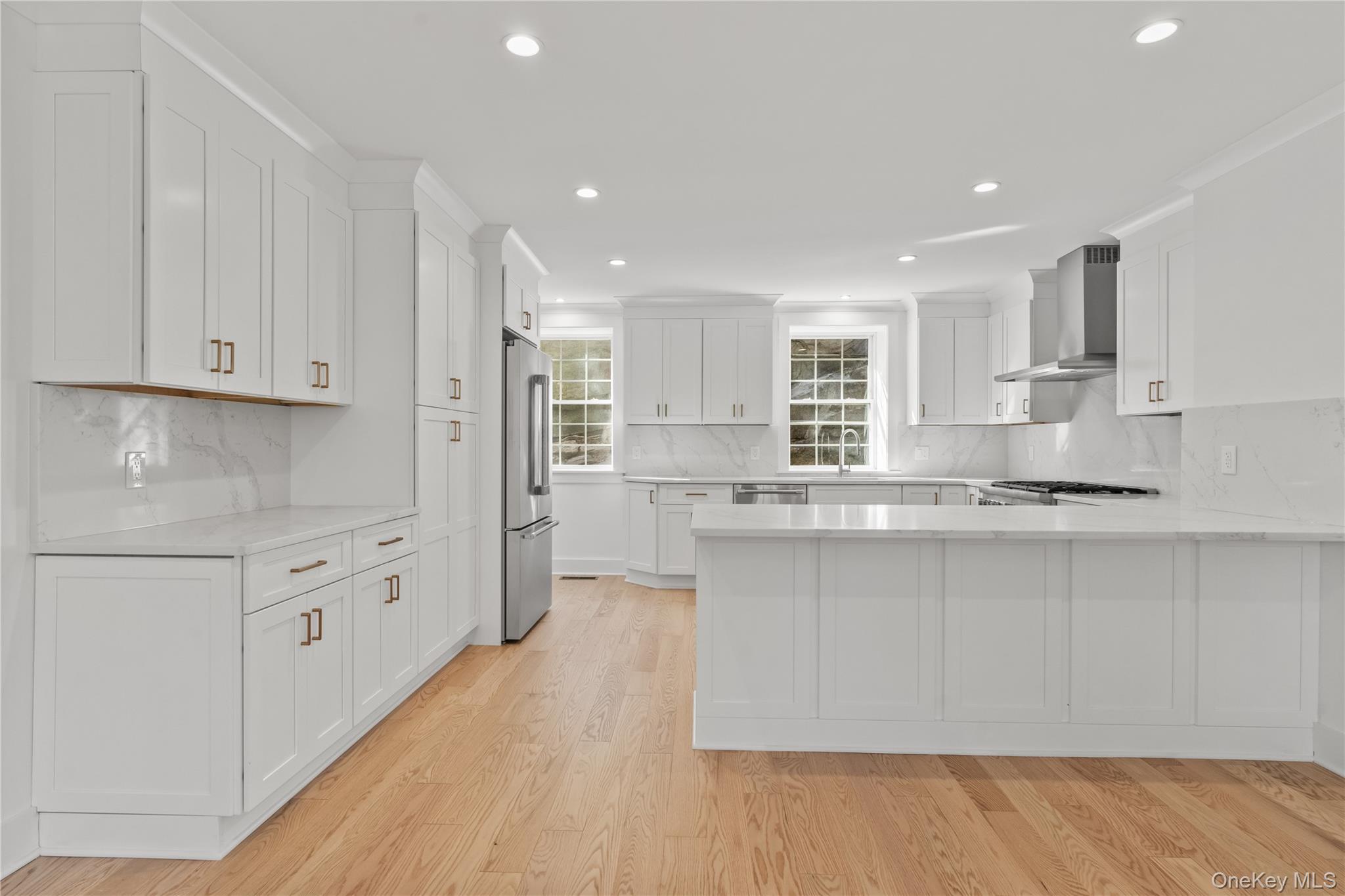 26 Latimer Lane Bronxville, NY 10708 - Photo 6 of 37 a kitchen with stainless steel appliances granite countertop a stove a sink and white cabinets