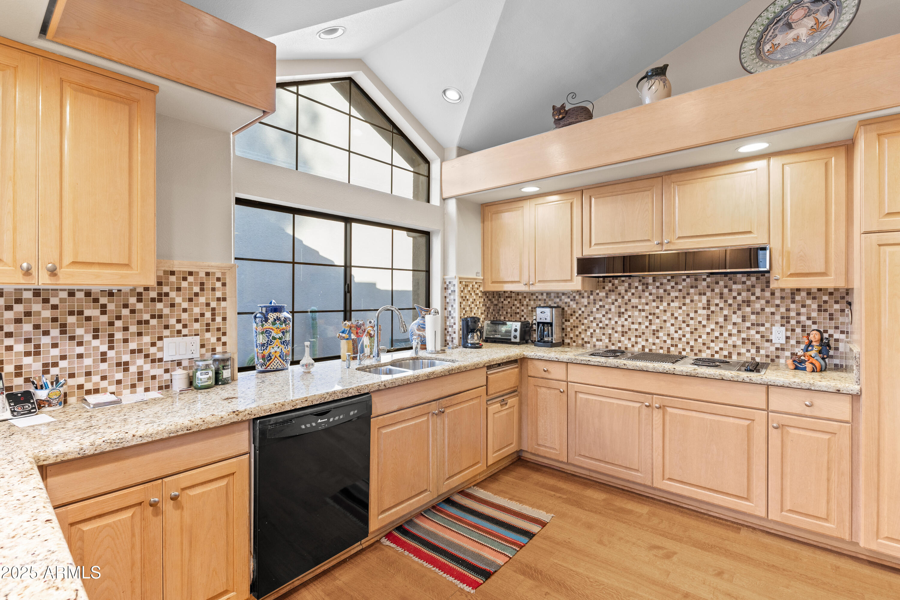 7525 East Gainey Ranch Road, Unit 164 Scottsdale, AZ 85258 - Photo 16 of 51 a kitchen with a sink stove and cabinets