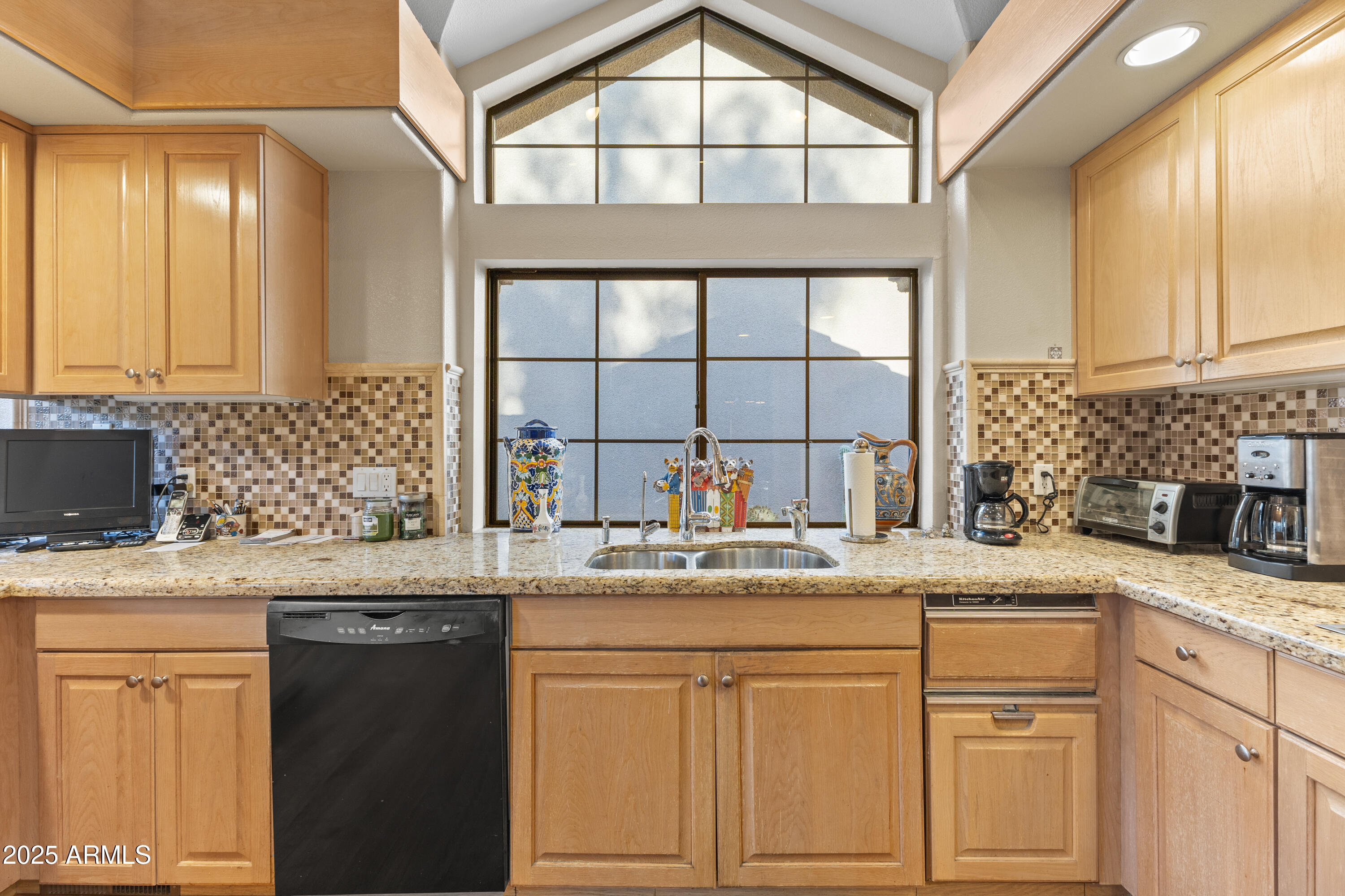 7525 East Gainey Ranch Road, Unit 164 Scottsdale, AZ 85258 - Photo 17 of 51 a kitchen with stainless steel appliances granite countertop a sink a stove and cabinets