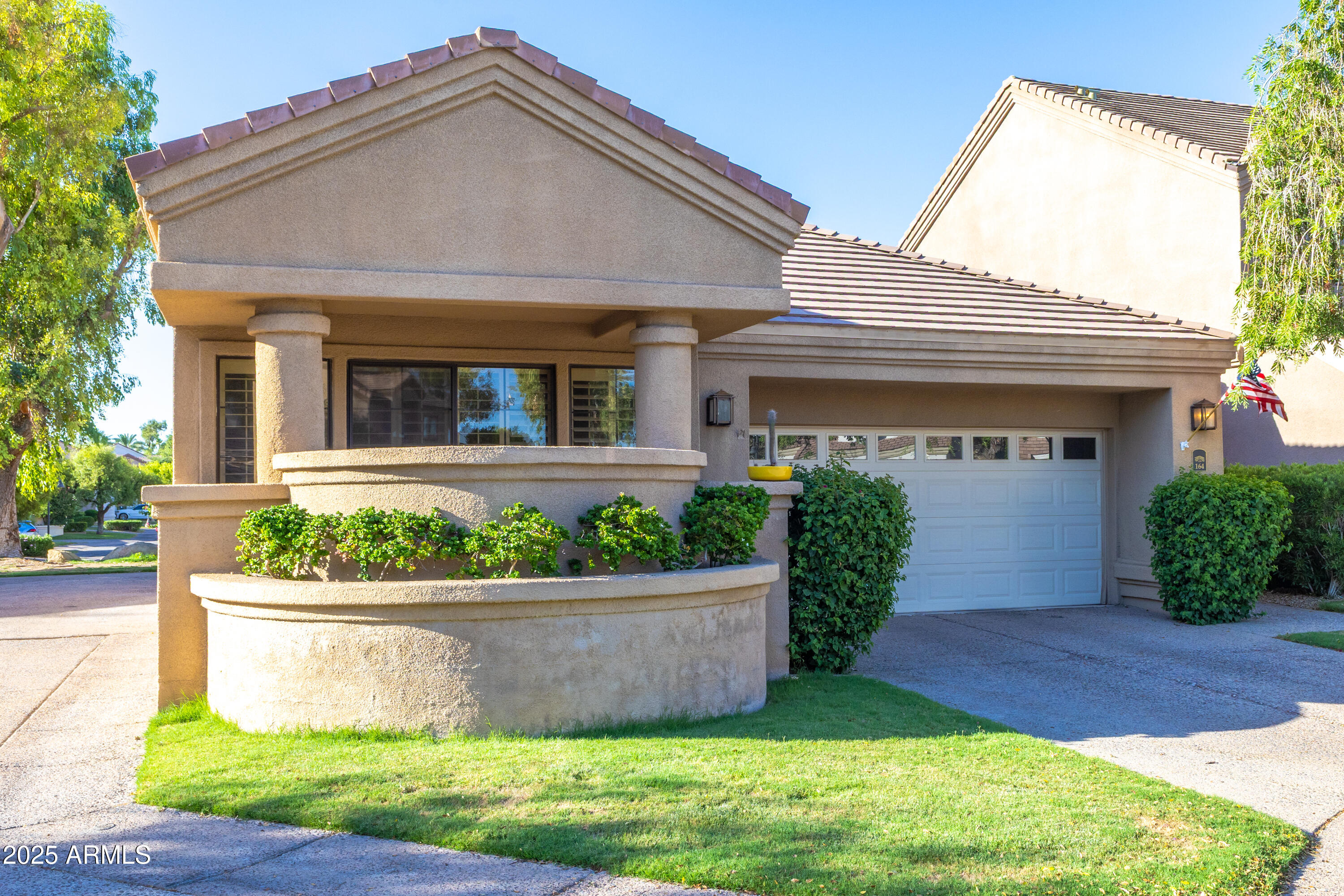 7525 East Gainey Ranch Road, Unit 164 Scottsdale, AZ 85258 - Photo 2 of 51 front view of a house with a yard