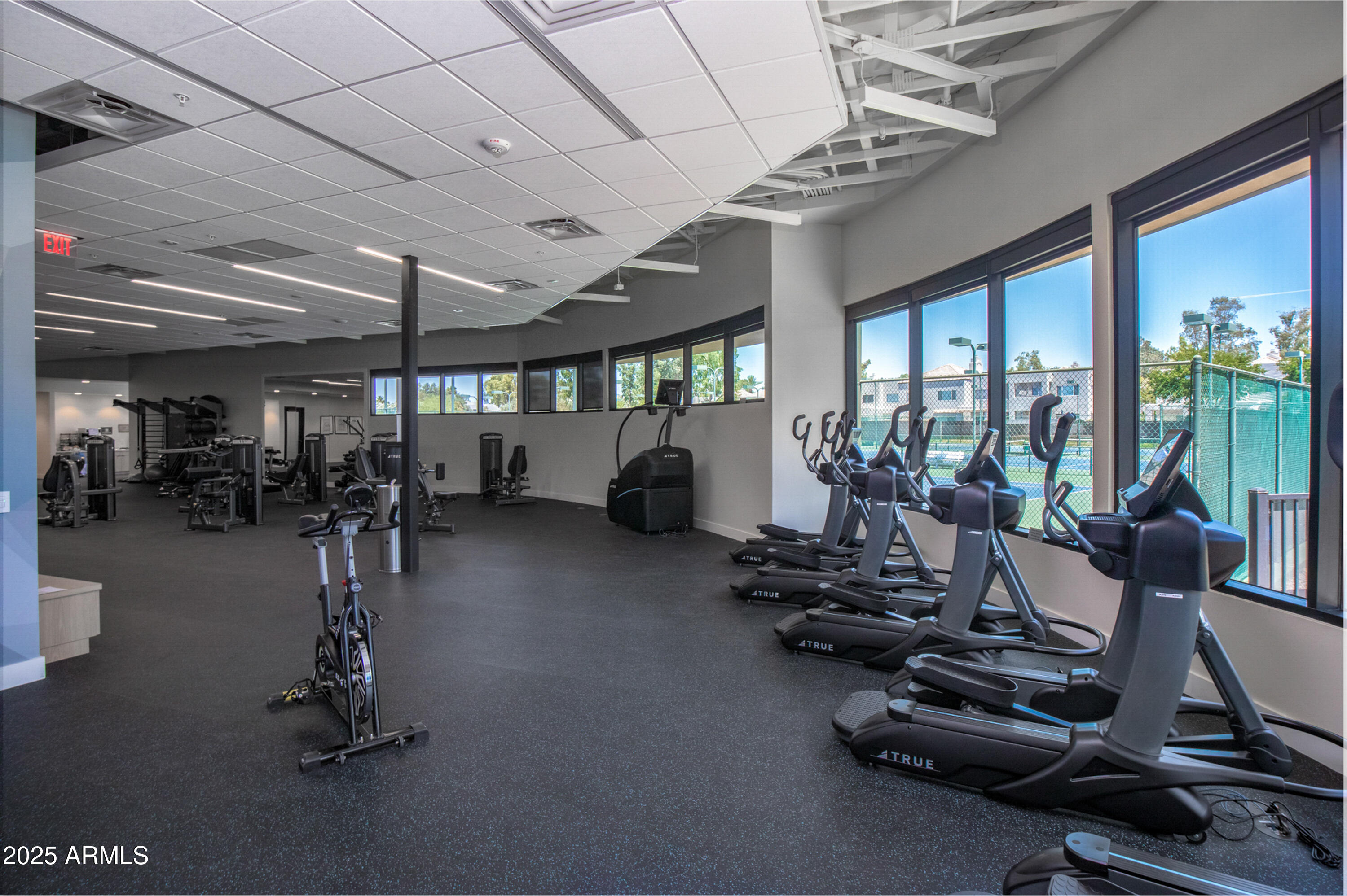 7525 East Gainey Ranch Road, Unit 164 Scottsdale, AZ 85258 - Photo 42 of 51 a room with gym equipment and a large window