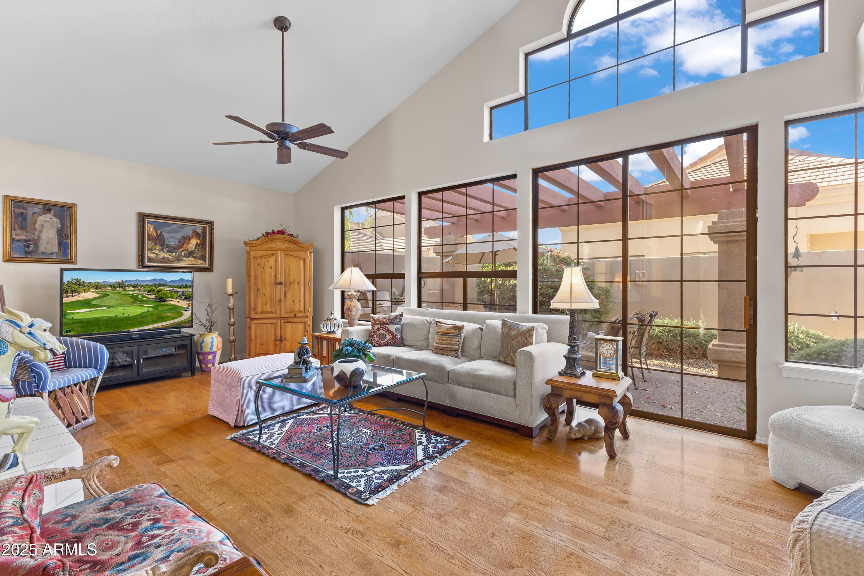 7525 East Gainey Ranch Road, Unit 164 Scottsdale, AZ 85258 - Photo 10 of 51 a living room with furniture and a floor to ceiling window