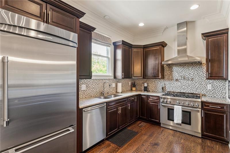 629 Boulevard Northeast Atlanta, GA 30308 - Photo 22 of 74 a kitchen with a sink and stainless steel appliances