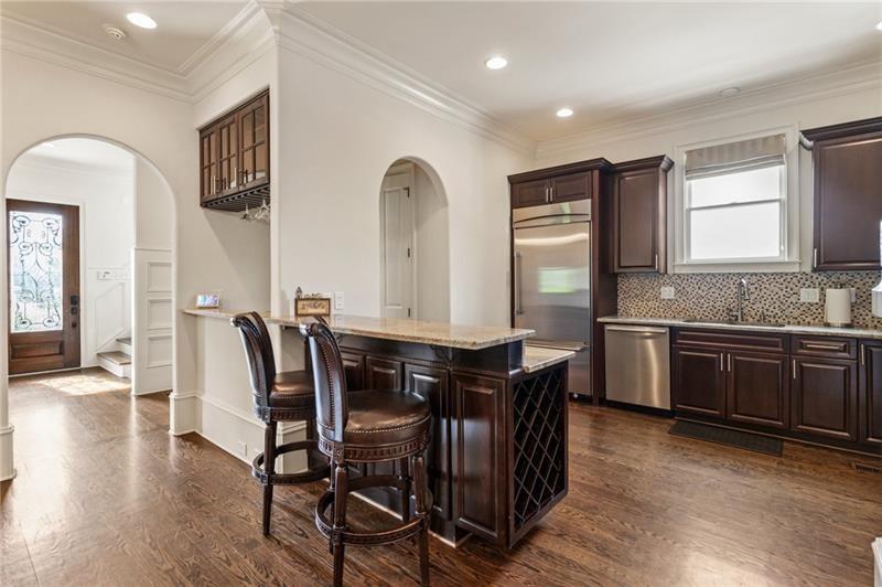 629 Boulevard Northeast Atlanta, GA 30308 - Photo 23 of 74 a kitchen with stainless steel appliances granite countertop a stove a sink a refrigerator dining table and chairs