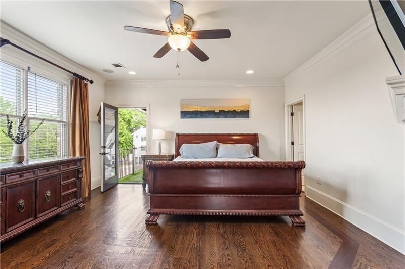 629 Boulevard Northeast Atlanta, GA 30308 - Photo 36 of 74 a bedroom with a bed chandelier and a large window