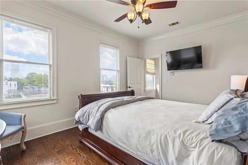 629 Boulevard Northeast Atlanta, GA 30308 - Photo 51 of 74 a bedroom with a large bed a flat tv screen and a window