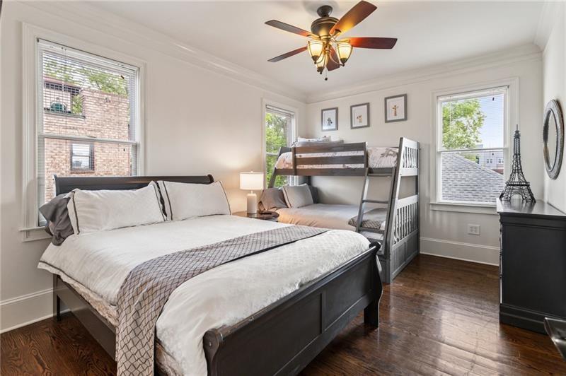 629 Boulevard Northeast Atlanta, GA 30308 - Photo 54 of 74 a bedroom with a bed and a chandelier