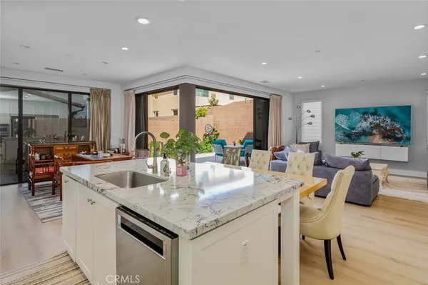 a kitchen with stainless steel appliances granite countertop a sink and a large window