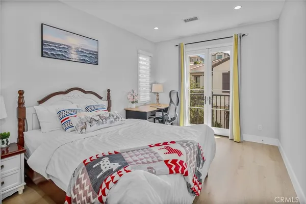 a bedroom with a large bed and a window