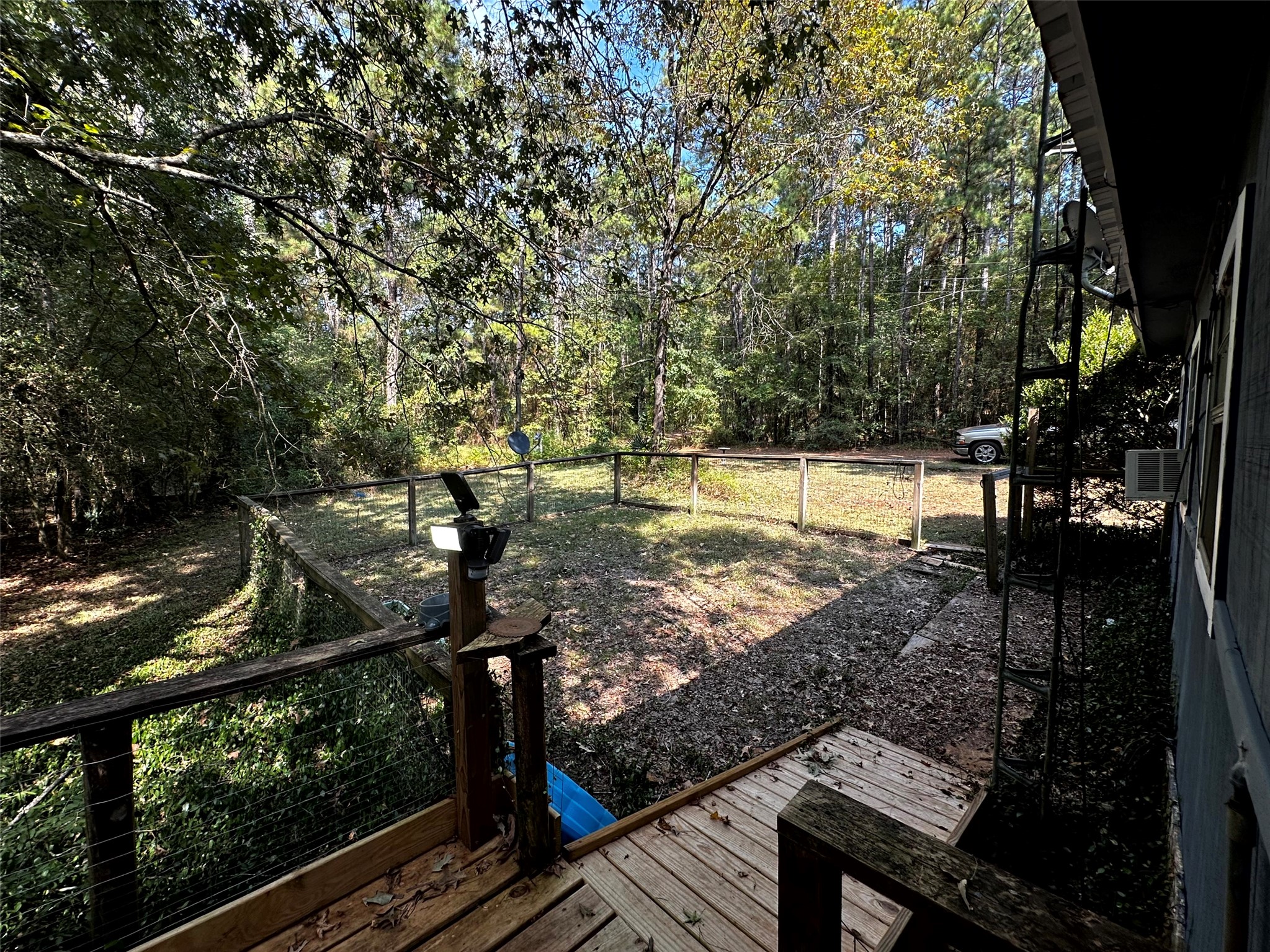539 Aa Loop Livingston, TX 77351 - Photo 23 of 47 The side yard is accessible through a door off the primary and features a gated area for your furry friends or little ones!