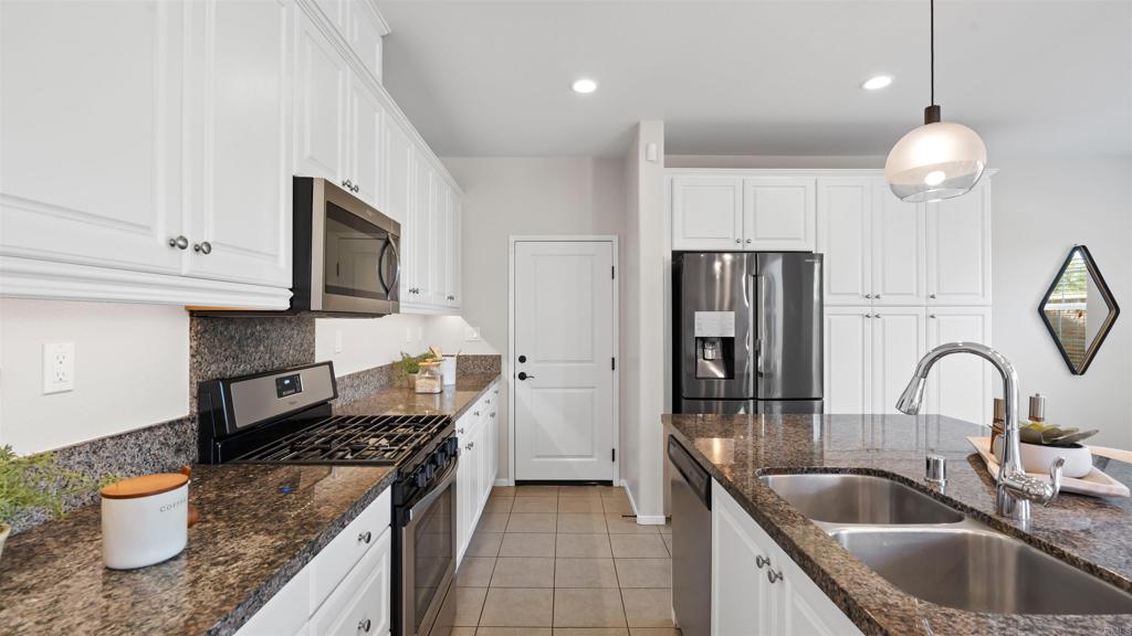 21578 Saddle Bred Lane Escondido, CA 92029 - Photo 11 of 49 a kitchen with stainless steel appliances granite countertop a sink a stove and refrigerator