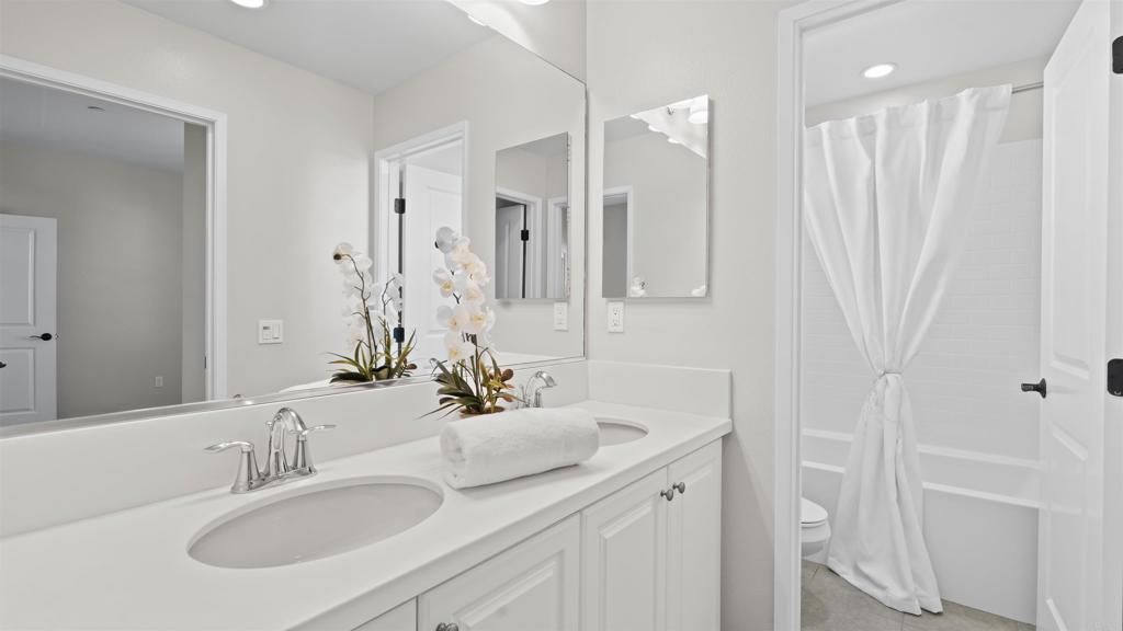 21578 Saddle Bred Lane Escondido, CA 92029 - Photo 34 of 49 a bathroom with double vanity sink a mirror and a shower