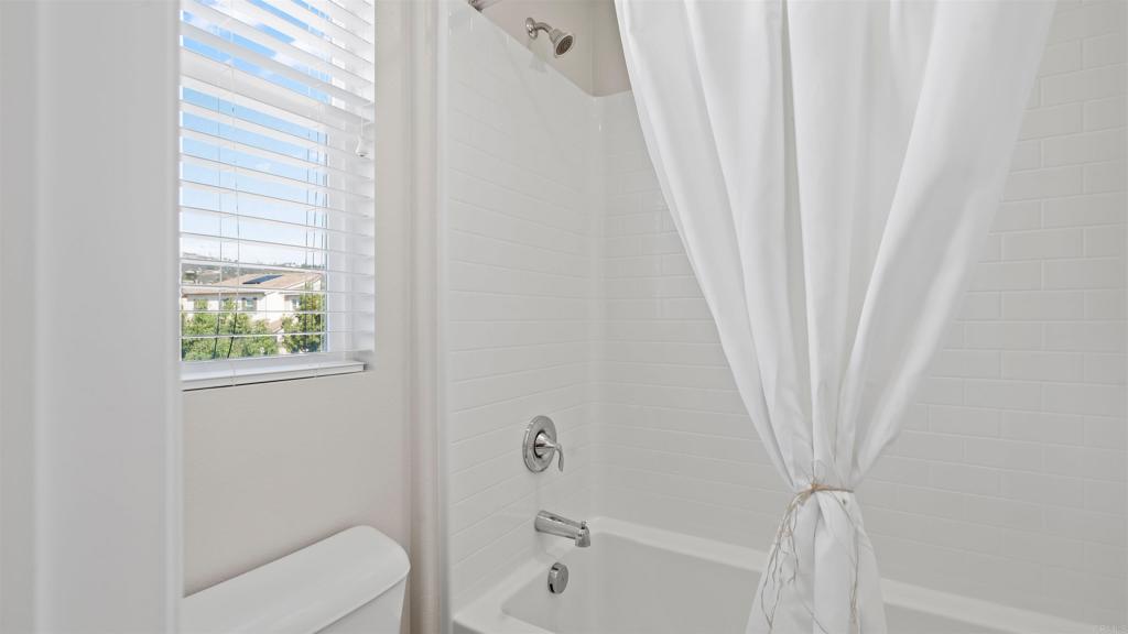 21578 Saddle Bred Lane Escondido, CA 92029 - Photo 36 of 49 a bathroom with a bathtub a window and a shower