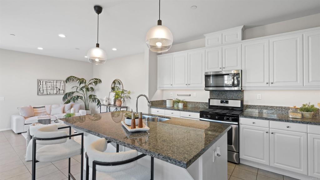 21578 Saddle Bred Lane Escondido, CA 92029 - Photo 9 of 49 a kitchen with stainless steel appliances granite countertop a sink a stove and cabinets