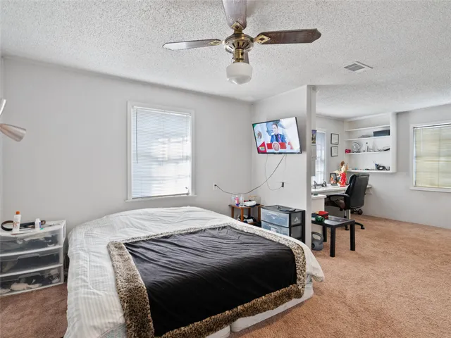 a bedroom with a bed and a table