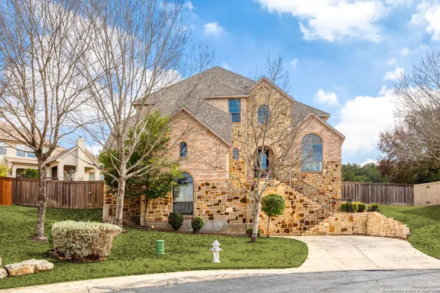 a view of a large white house with a yard