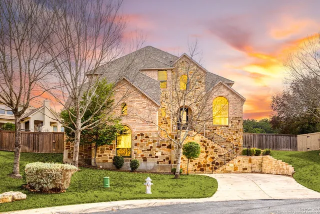 a view of a white house with a yard and plants