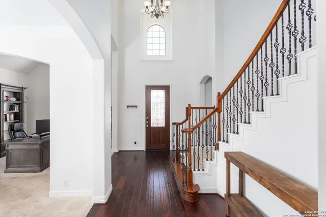 a view of entryway and hall with wooden floor