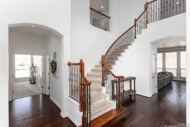 a view of staircase with wooden floor and windows
