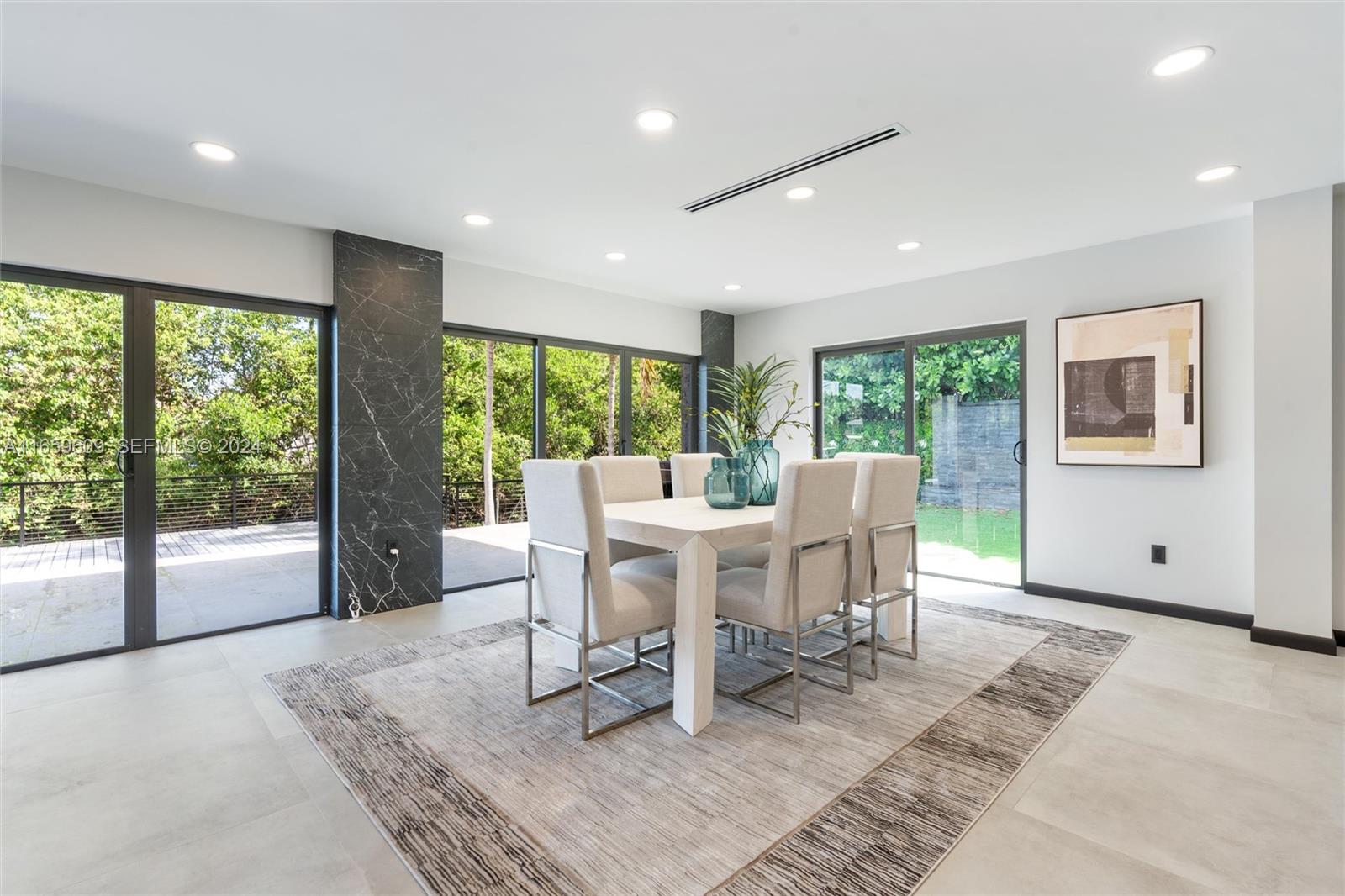 2261 Northeast 192 Street Miami, FL 33180 - Photo 7 of 24 a view of a work space with wooden floor and a rug