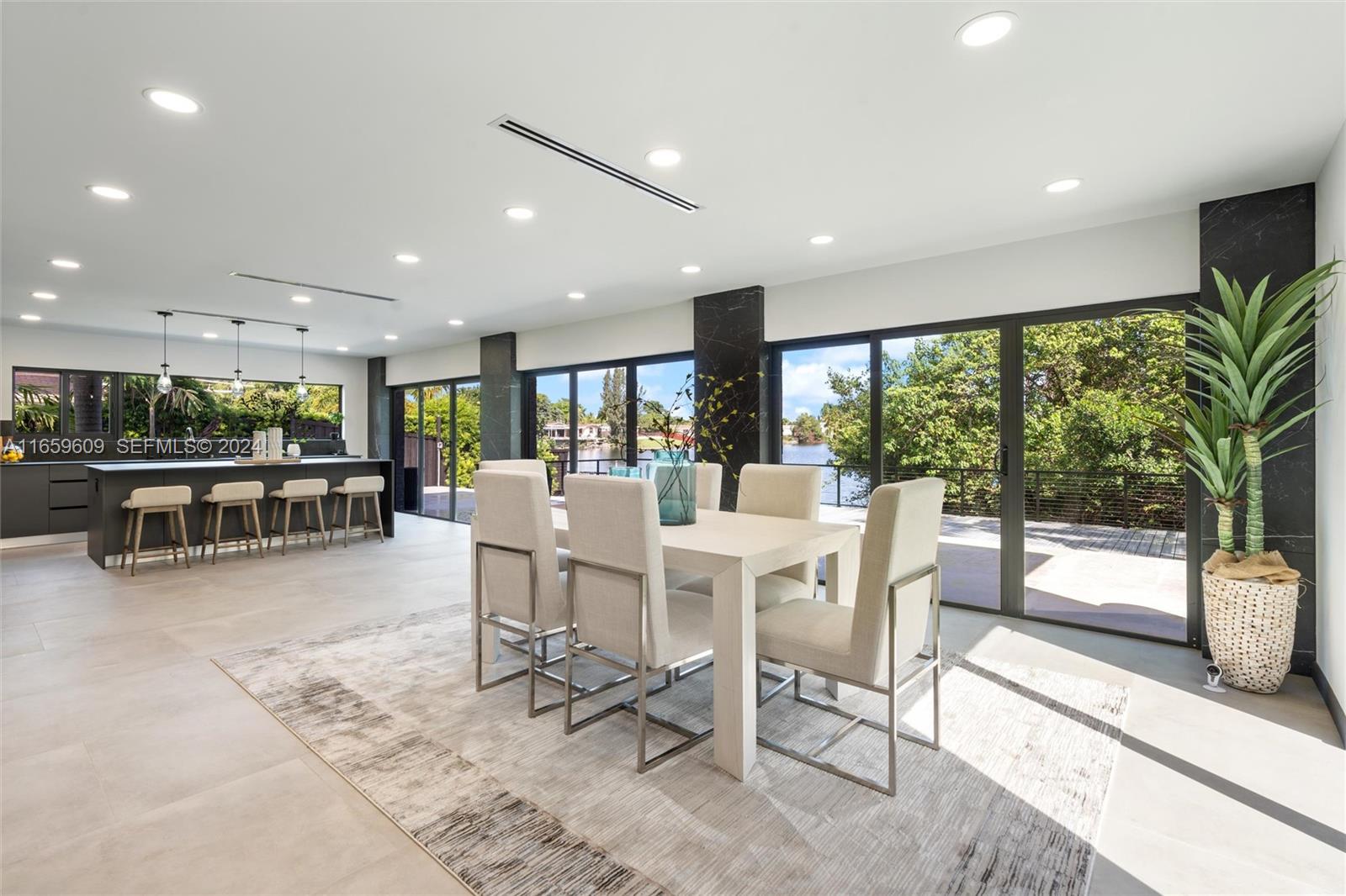 2261 Northeast 192 Street Miami, FL 33180 - Photo 9 of 24 a dining room with furniture and a floor to ceiling window