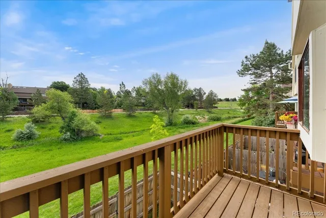 a view of balcony with wooden floor and fence
