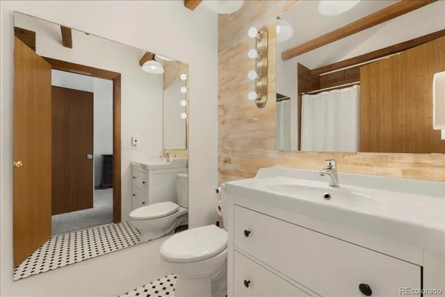 a room with furniture a air conditioner vent and a window