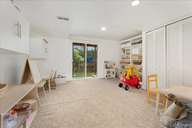 a bedroom with a bed and a book shelf