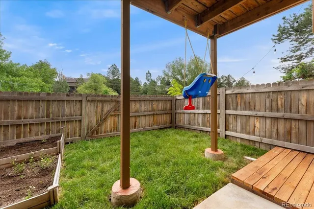 a balcony with wooden floor in outdoor space and yard