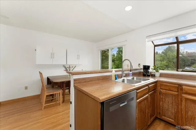 a kitchen with a sink and chairs