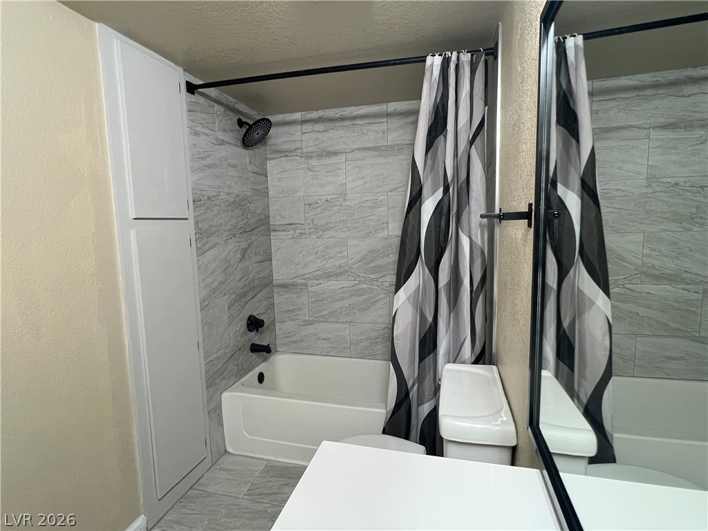 8101 West Flamingo Road, Unit 2161 Las Vegas, NV 89147 - Photo 11 of 15 A clean, functional bathroom awaits with sleek tile flooring and a tub/shower combination.