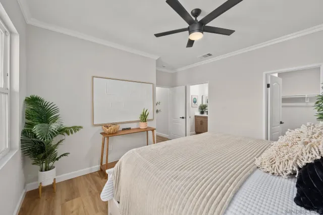 a bedroom with a bed and a potted plant