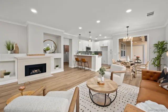 a living room with furniture a fireplace and a chandelier