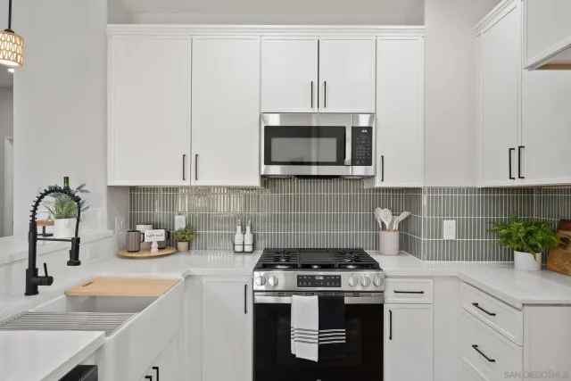 a kitchen with cabinets stainless steel appliances a sink and a counter top space