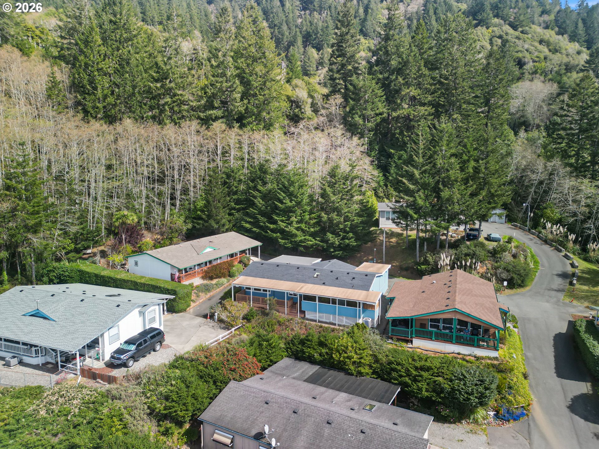 98041 Hallway Road, Unit 41 Brookings, OR 97415 - Photo 47 of 48 an aerial view of residential houses with outdoor space and trees
