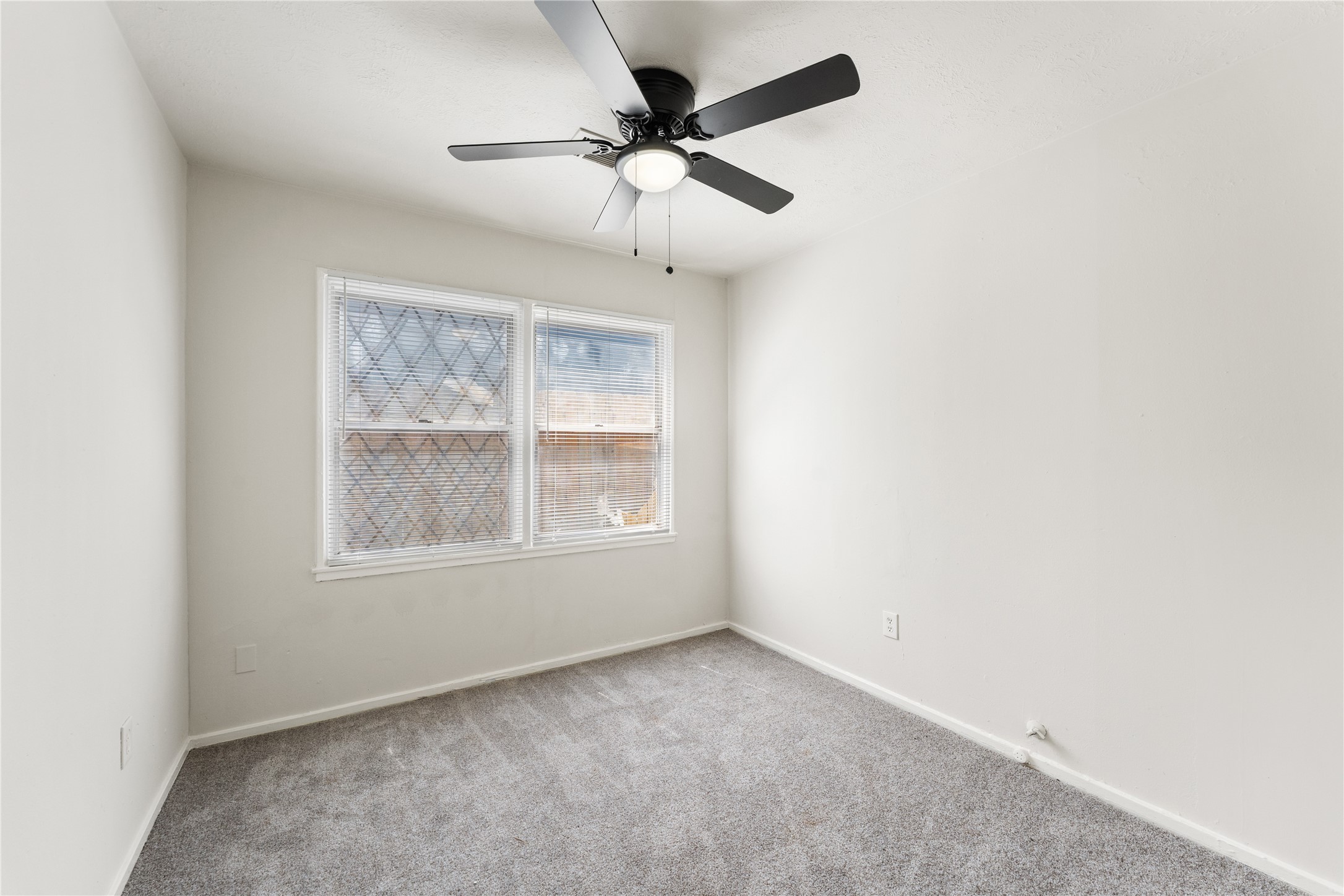 7725 St Lo Road Houston, TX 77033 - Photo 18 of 26 an empty room with a window and a fan