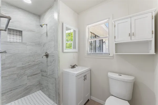 a bathroom with a toilet sink and shower