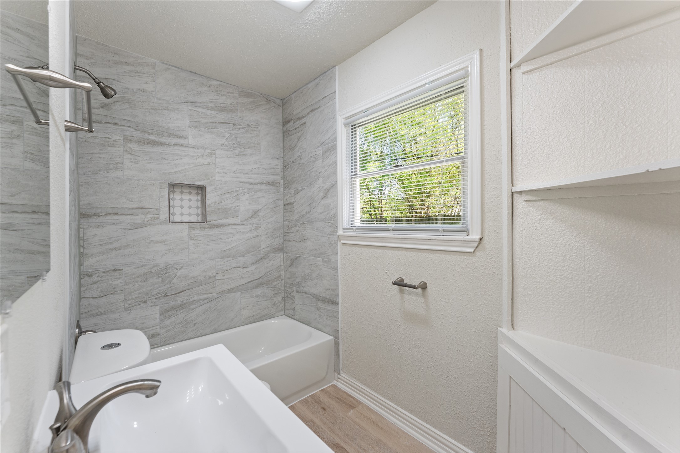 7725 St Lo Road Houston, TX 77033 - Photo 22 of 26 a bathroom with a sink a bathtub and shower