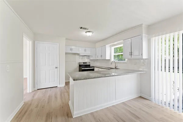 a kitchen with stainless steel appliances granite countertop a sink and cabinets