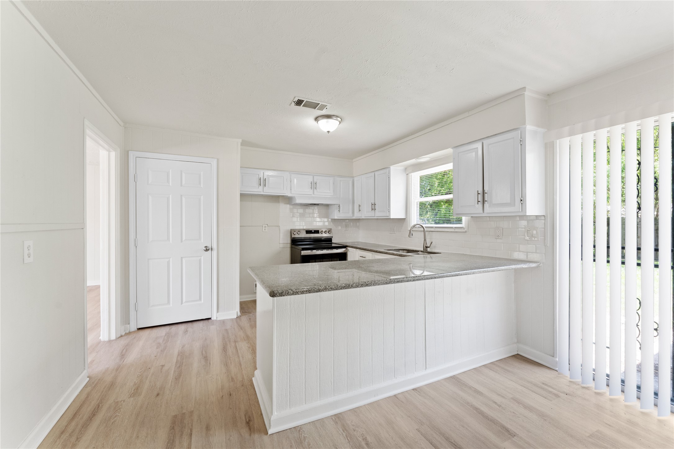 7725 St Lo Road Houston, TX 77033 - Photo 9 of 26 a kitchen with stainless steel appliances granite countertop a sink and cabinets