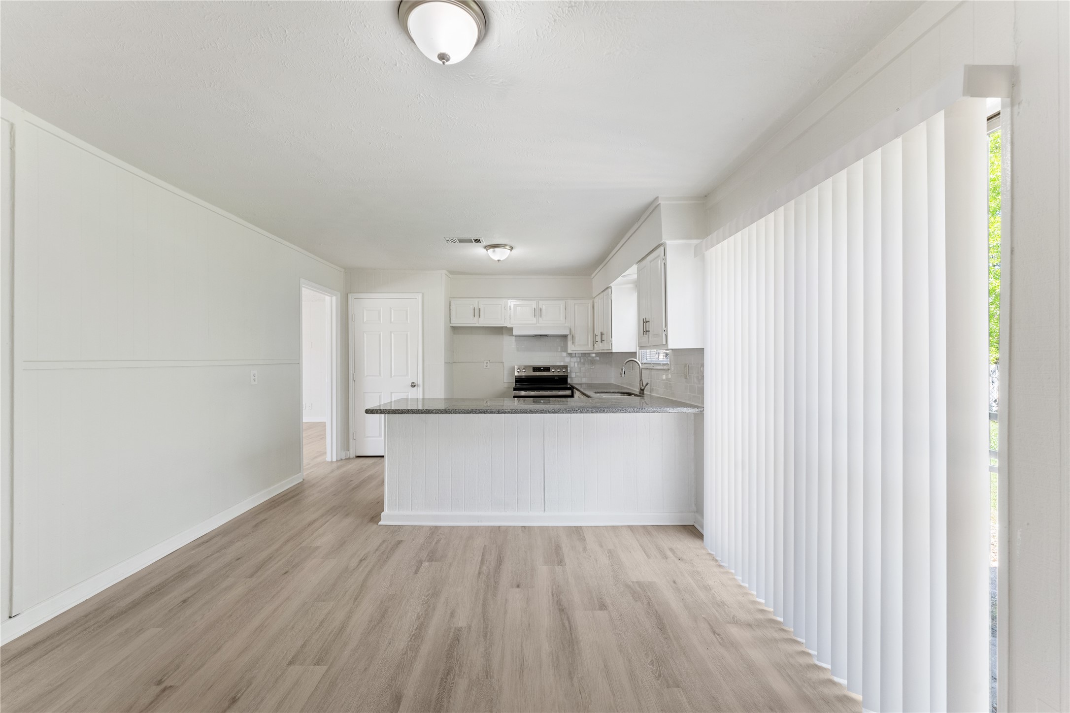 7725 St Lo Road Houston, TX 77033 - Photo 10 of 26 a view of kitchen with wooden floor