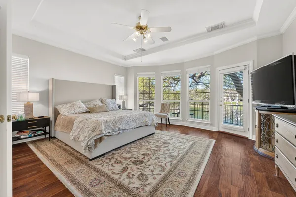 a bedroom with a large bed and a flat tv screen on a dresser